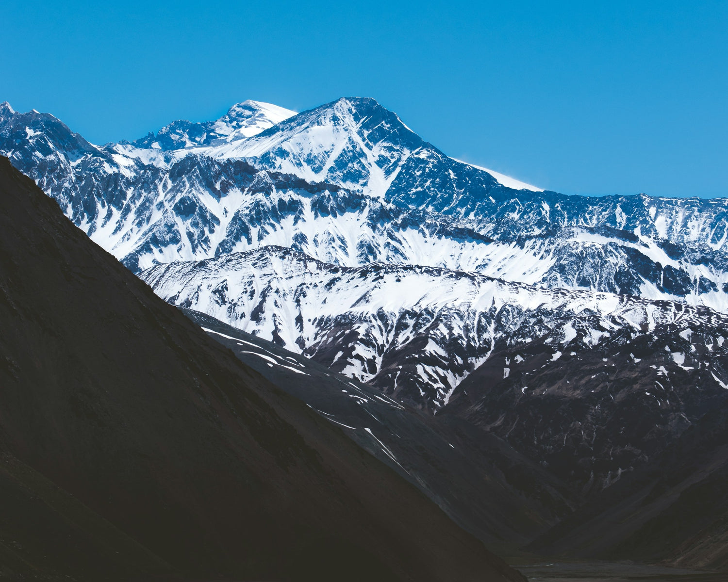 Dry rocky Chilean Andes near Santiago with snow-capped peak