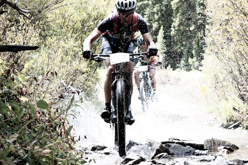 Mountain biking through forest trail