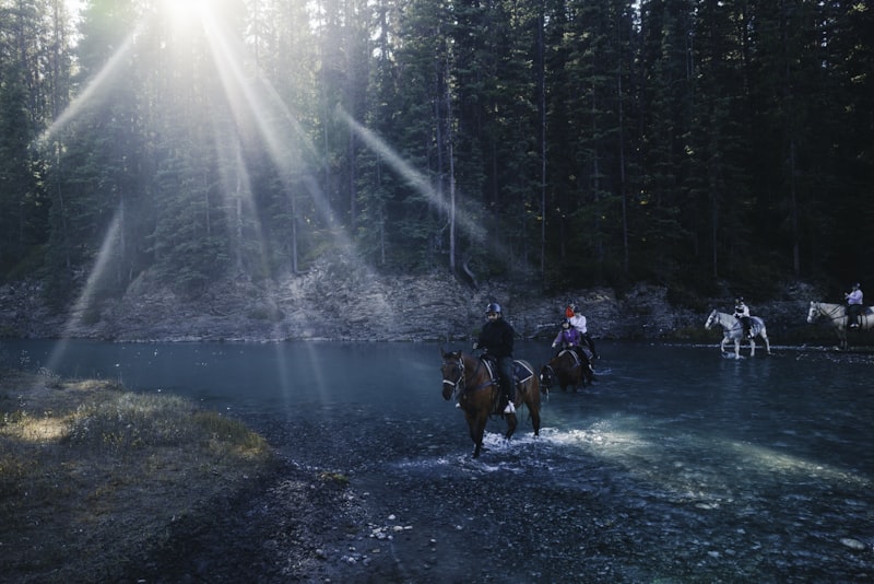 Horseback riding crossing mountain river